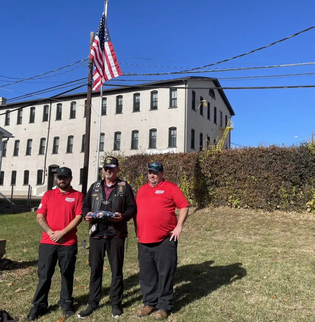 Lew Hansen (right) poses with fellow flag Ambassador and an Operation Old Glory flag recipient.