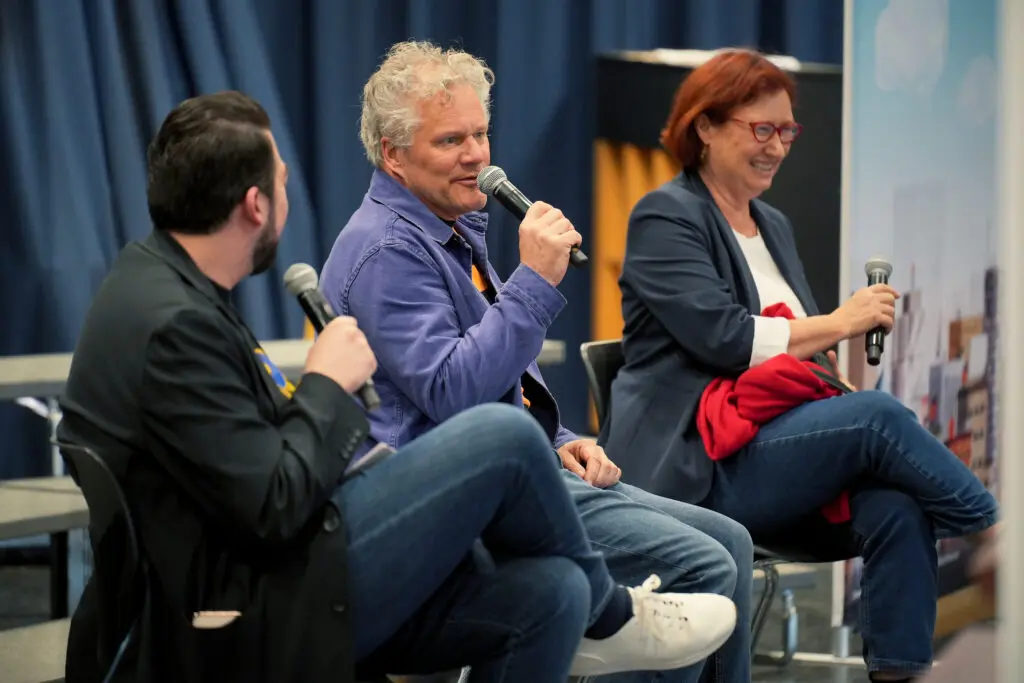 Comcast employee Fernando Cardenas hosts a fireside chat and audience question-and-answer session with Director and Screenwriter Peter Hastings, and Producer Karen Foster (pictured L to R).