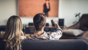 woman and man sitting together on a couch