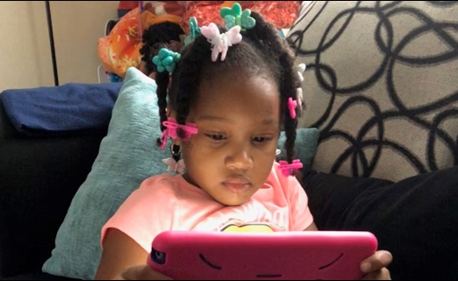 little girl on ipad