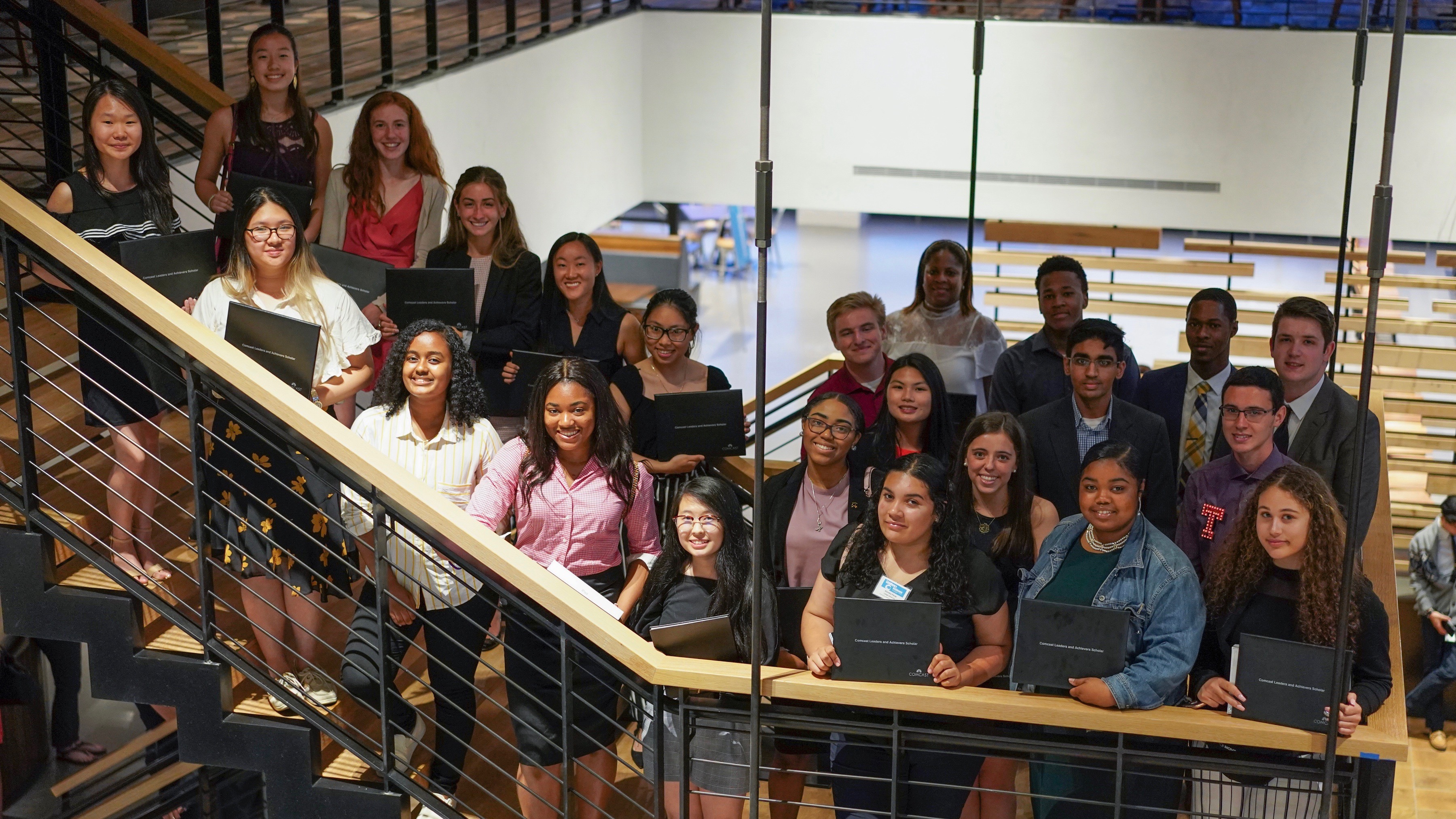 group of people posing on a staircase