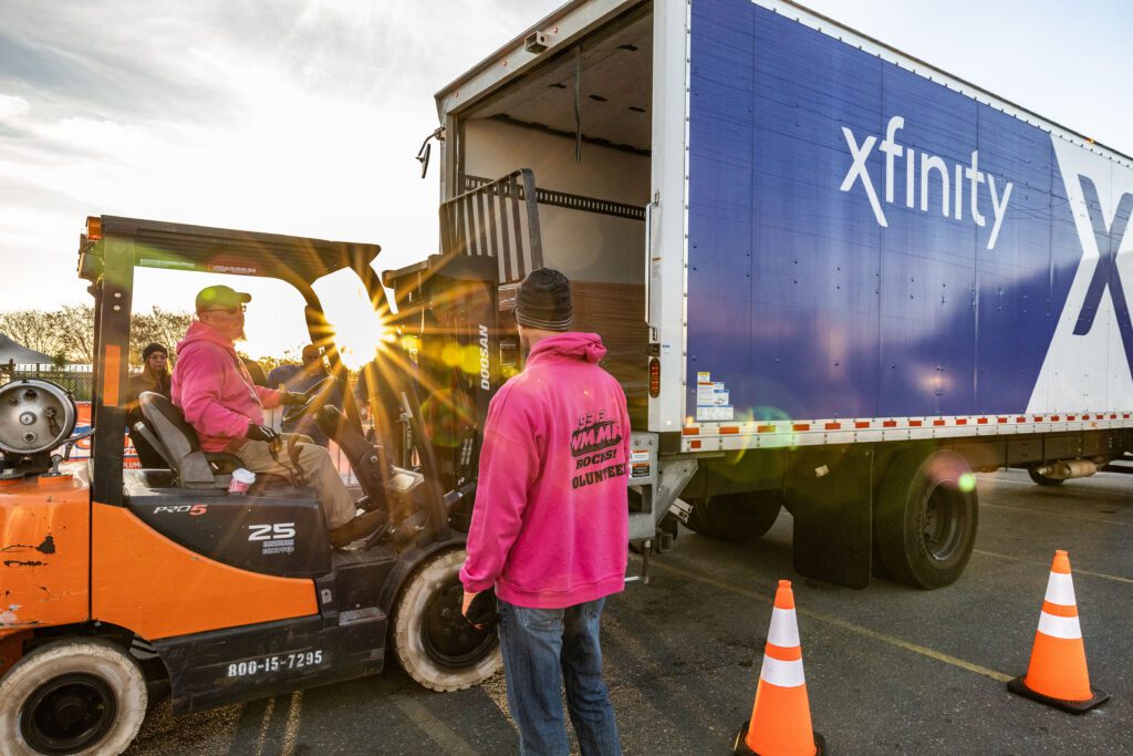 WMMR unloading Camp Out for Hunger donations from an Xfinity Box Truck. 