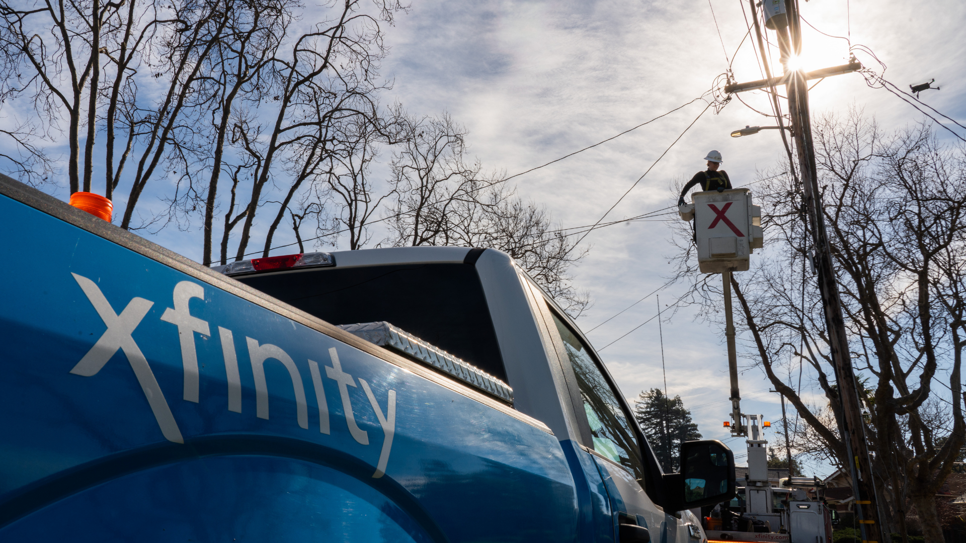 Xfinity technician doing aerial work.